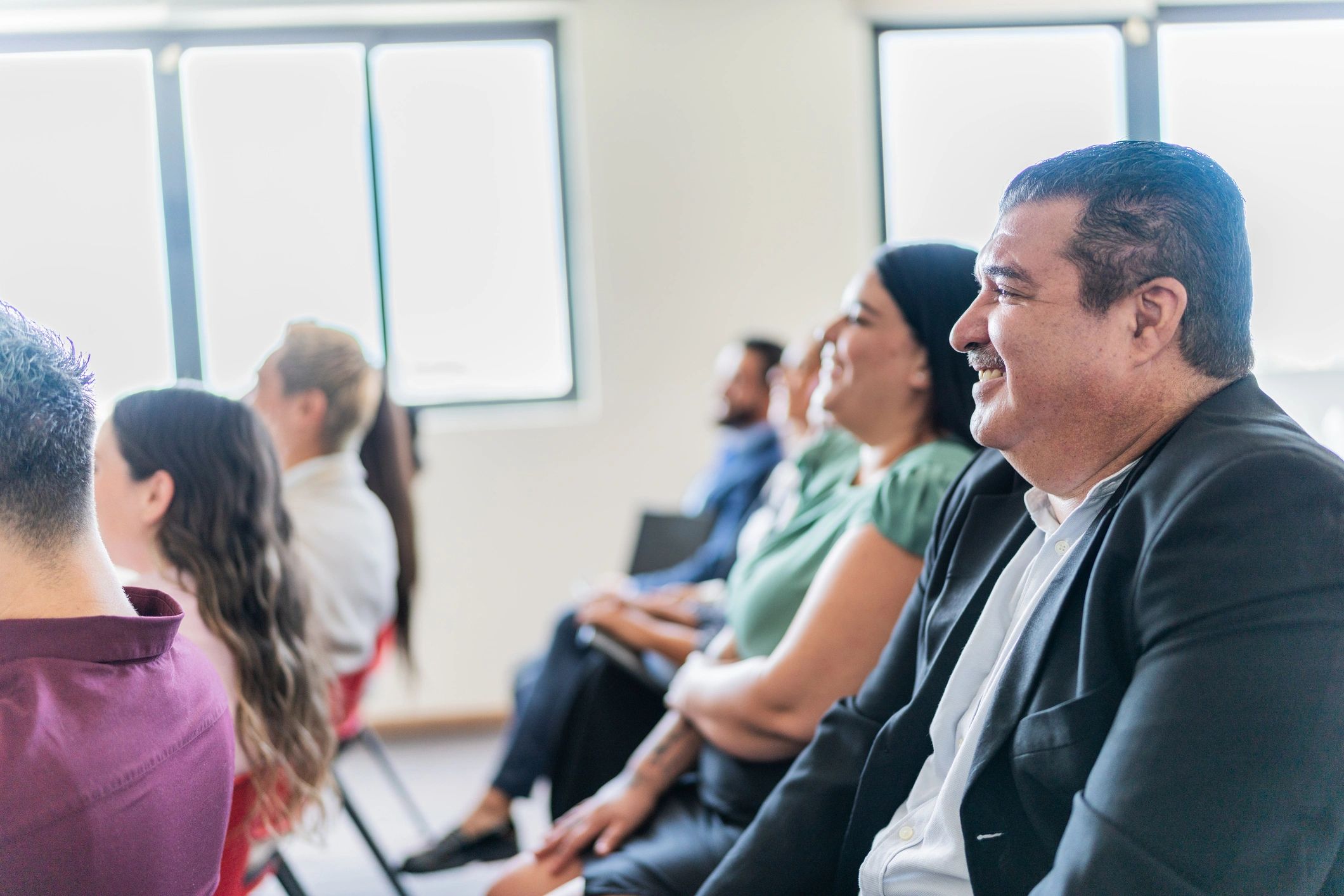 Volunteers listening to a community presentation